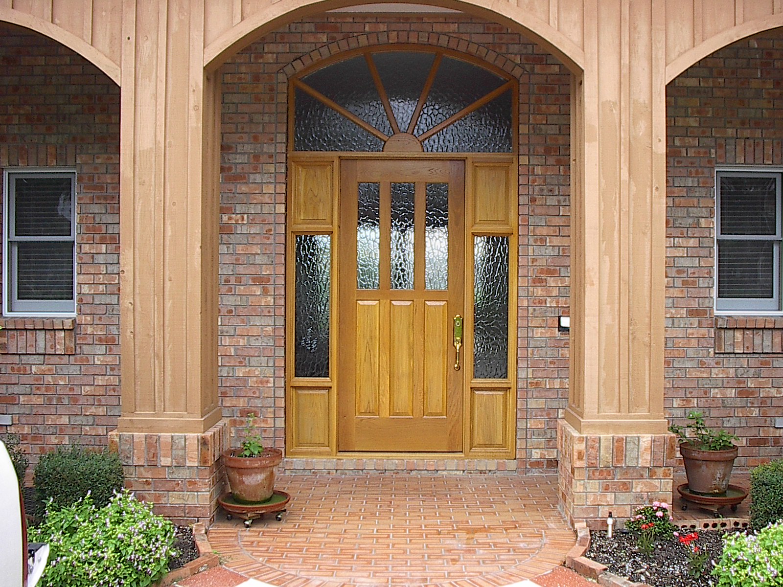 Custom oak entry door with sidelights and fanlight